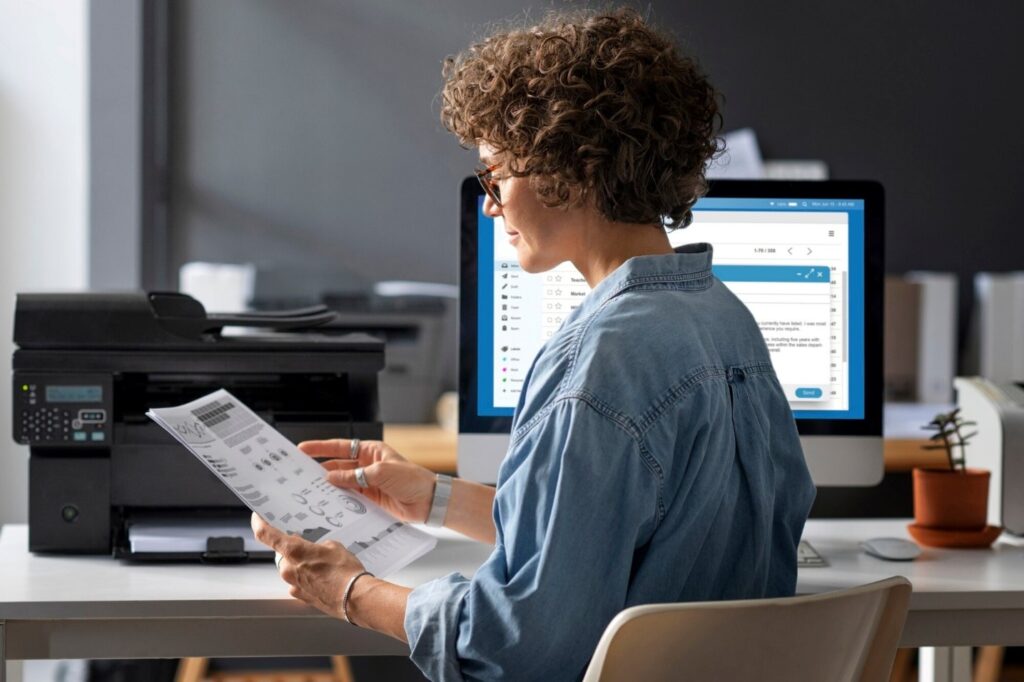 Woman sitting at desk medium shot
